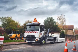 A 12-tonne / 14-tonne Renault Trucks D fitted with a Hiab crane on a roadworks site in town