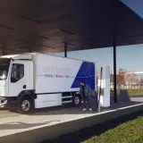 Man charging a Renault Trucks E-Tech D